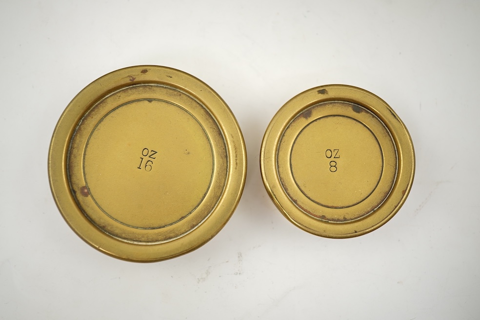 A Sampson Mordan & Co. set of brass postal scales on an oak base with weights, 27cm wide, with engraved prices for Inland Letter Post, etc.